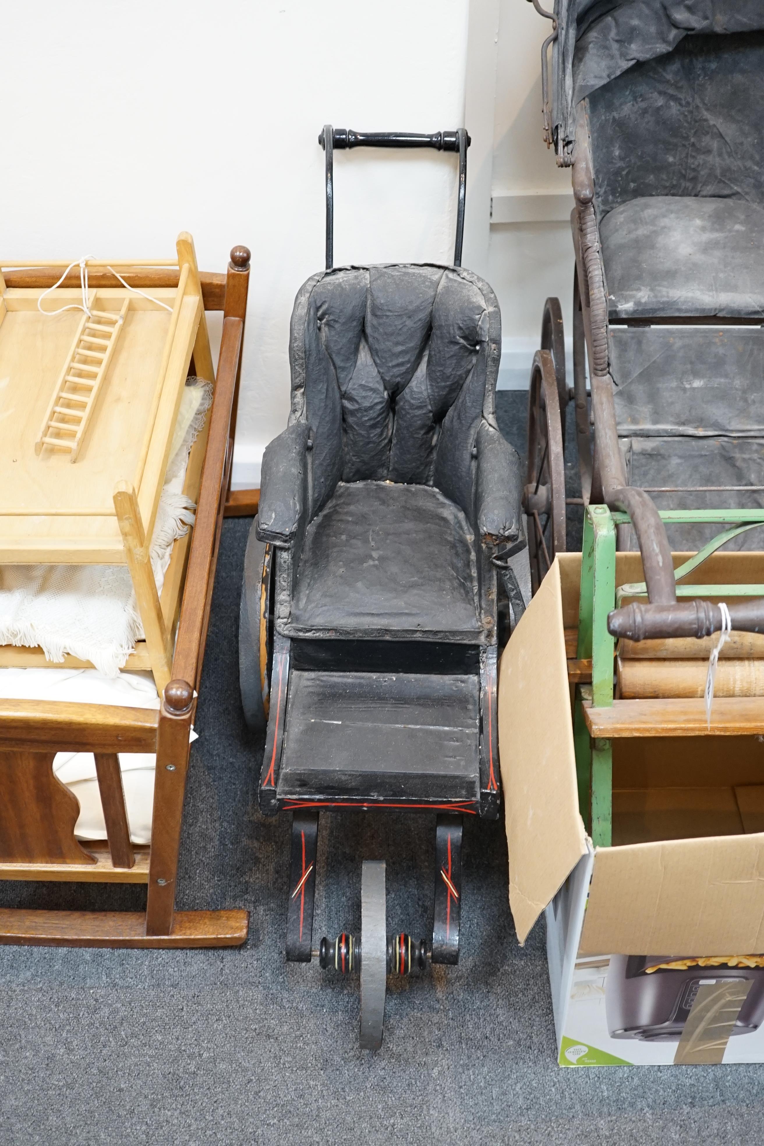 A collection of nine doll’s cribs of wood or wrought iron construction, together with two nineteenth century style doll’s ’bath chairs’, a toy mangle, Disney themed Snow White carpet sweeper and a boxed child’s sewing ma